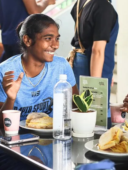 Female athletes enjoying a meal and conversation between sessions. A strong community and positive environment are key components of our training camps.