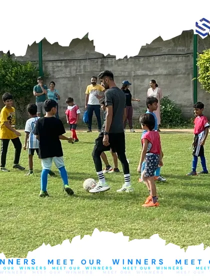 A coach guides a group of young players through a positioning drill. This kind of hands-on instruction is crucial for developing game awareness and learning to work together as a cohesive unit on the field.