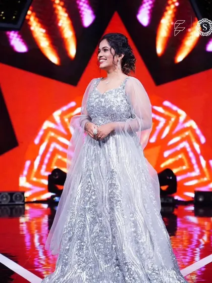 Singer Sayli Kamble looking absolutely stunning on stage in a silver gown and jewelry from our collection. We love seeing our clients shine.