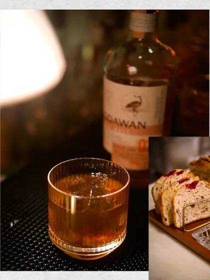 A pairing of a Godawan single malt cocktail with a savory, fruit-studded bread. This photo showcases how we thoughtfully pair our spirits with unique bar bites to create a complete tasting experience.