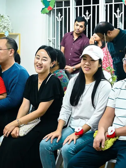 Parents watch their children perform, their faces beaming with pride and joy.
