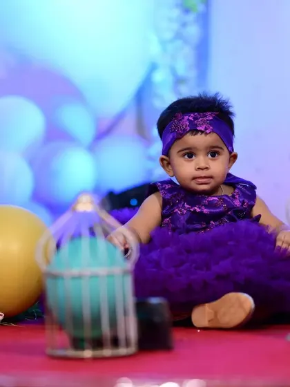 A sweet moment at a party, with the custom purple dress looking picture-perfect. The comfortable fit allows for sitting and playing, ensuring the child enjoys her event without any fuss.