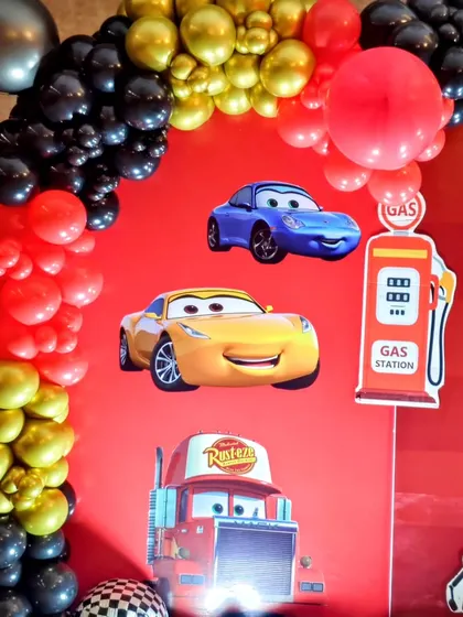 Detail shot of the Cars backdrop with various character stickers and a gas station prop.