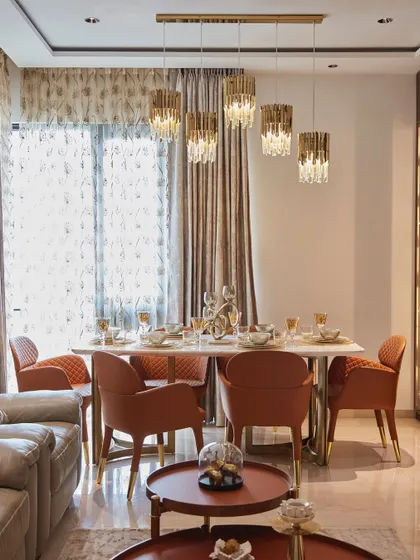 A closer look at the open-concept dining area, showing the sleek crockery unit with integrated lighting and the elegant dining set. The space is designed for entertaining in style.