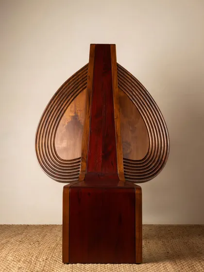 Various angles of the Vismayam chair, showcasing its intricate details, the contrast of different wood grains, and its powerful, sculptural presence. Each view offers a new perspective on this piece of collectible, art-inspired furniture.