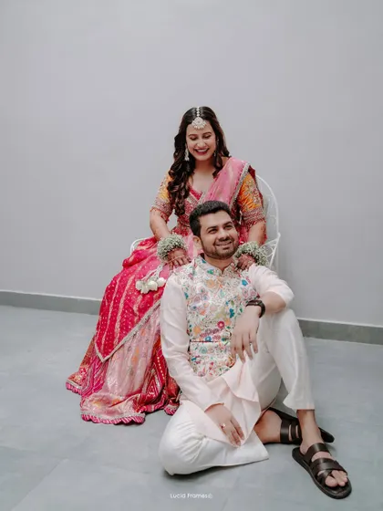 A relaxed and happy portrait of the couple, showcasing their beautiful and coordinated outfits.