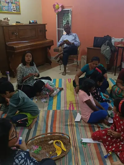 A wide view of the room during craft time, showing how families create together.