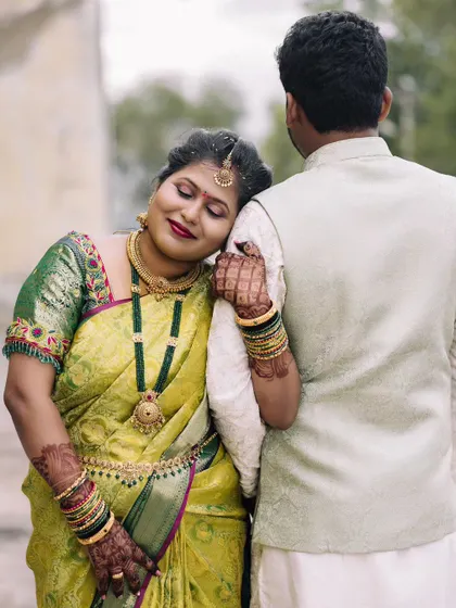 This was a beautiful outdoor engagement shoot. I created a natural, dewy makeup look with a bold red lip that stood out beautifully against her green and yellow saree. The makeup was designed to be long-lasting and picture-perfect.
