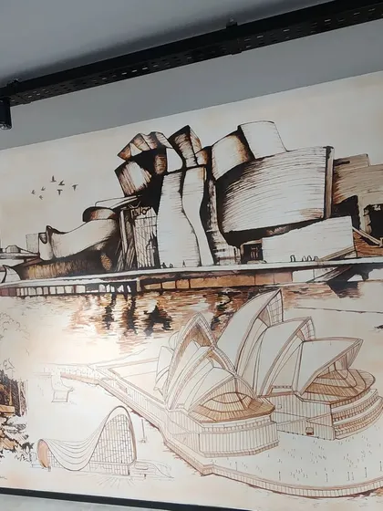 A close-up of the architectural mural, focusing on the renderings of the Guggenheim Museum Bilbao and the Sydney Opera House.
