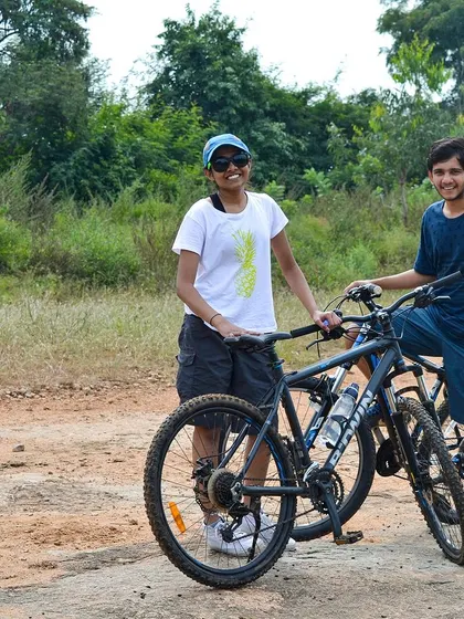 Two friends taking a break with their cycles during our Ramanagara off-road adventure.