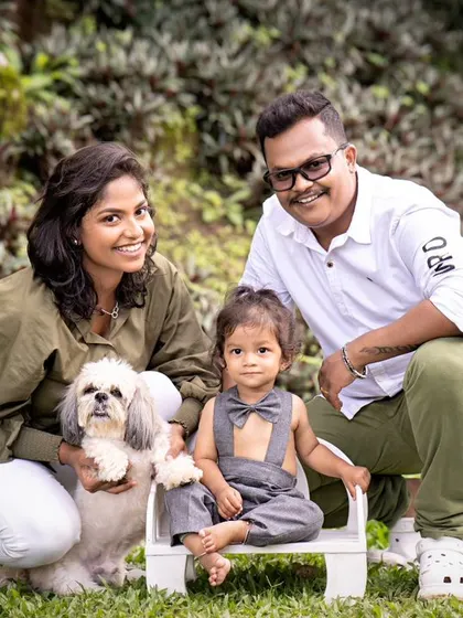A family portrait taken in a lush green park, complete with their adorable pet dog. I love it when families bring their furry members along for the shoot.