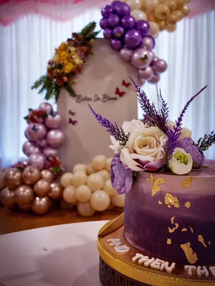 A close-up of the cake for the purple "Babies in Bloom" shower, showing how the cake decoration perfectly matches the theme.