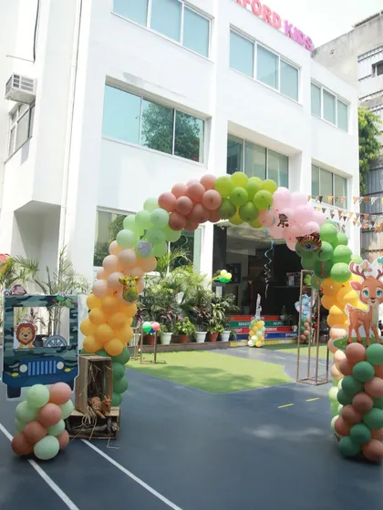 A full view of our venue transformed for a jungle party. The balloon arch, animal photo booth, and themed columns create a cohesive and exciting safari adventure.