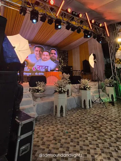 A side view of the stage, highlighting the different layers of the setup from the floor tiles to the draped ceiling. Every detail is considered to create a cohesive environment for the event.