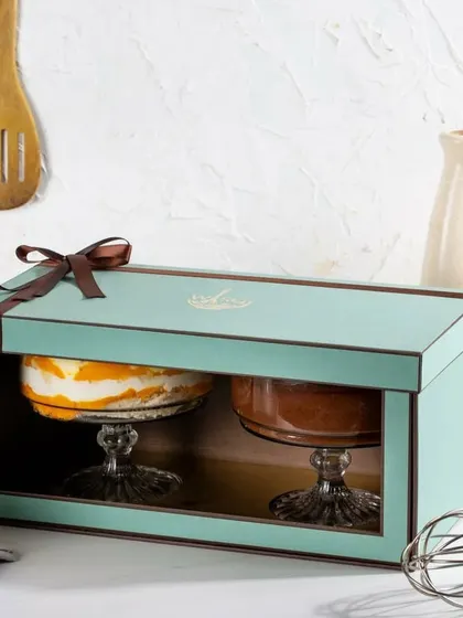 Our twin gift set in Tiffany blue, showcasing a vibrant Mango Trifle next to a rich Dark Chocolate Mousse. This packaging allows you to gift a duo of indulgence.