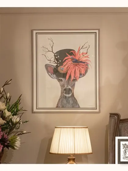 I love wall art that adds a dash of whimsy and personality. This print of a deer wearing a flamboyant hat is a playful and charming piece that is sure to bring a smile to anyone's face.