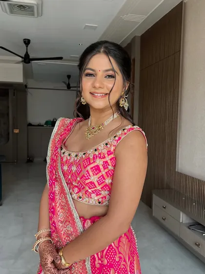 Flawless as ever. This look for a pre-wedding function features a beautiful pink bandhani lehenga, paired with soft, natural makeup.