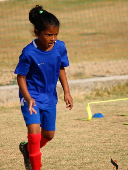 Our summer camps are for everyone. A young female athlete shows great intensity during a practice drill.