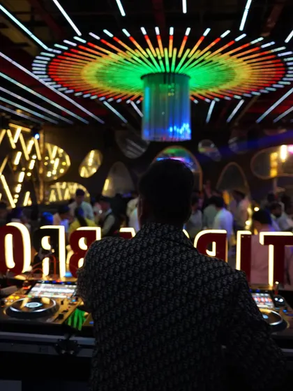 A wider view of my setup at Tipsy Bro. You can see the whole system, the lights, and the crowd in front of me. This is my office, and I love what I do.