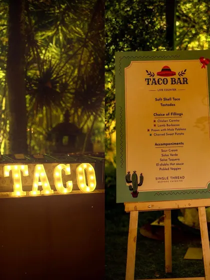 The menu and setup for one of my Taco Bars, featuring a lit-up "TACO" sign. I offer a variety of fillings like Chicken Carnitas, Lamb Barbacoa, and Charred Sweet Potato.