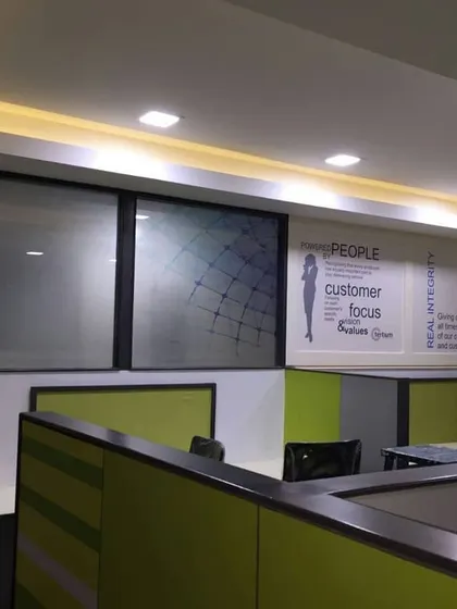 The office space with cove lighting along the ceiling, adding a warm ambiance to the work environment.