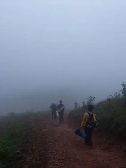 Participants walking along a misty trail during our silent trek. The concept of walking in silence through nature allows for a deeper connection with oneself and the environment.