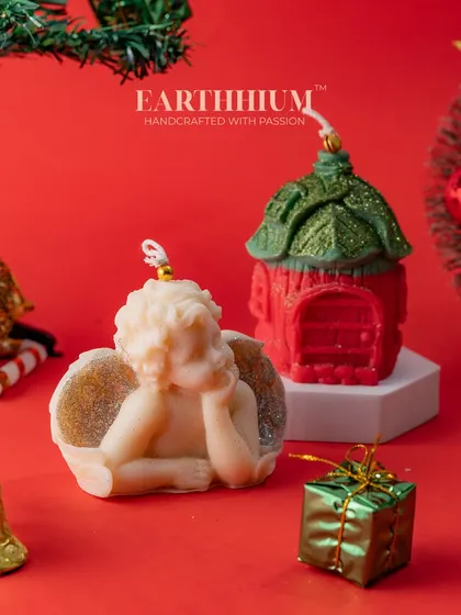 An angel and a house candle set, perfect for creating a serene and magical Christmas display.
