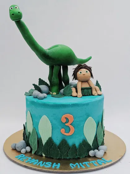 A sweet cake inspired by The Good Dinosaur, with Arlo and Spot ready for a prehistoric party.