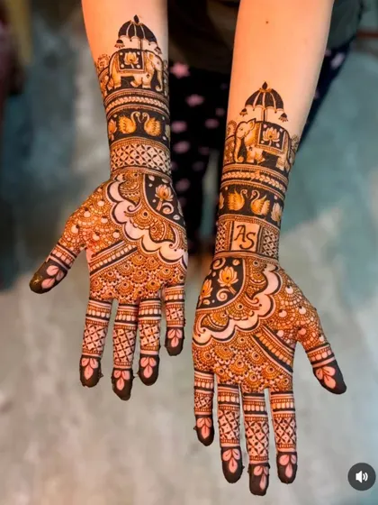 This design combines bold, dark sections with delicate, lighter patterns for a striking contrast. It features elephant processions and the initials 'AS'.