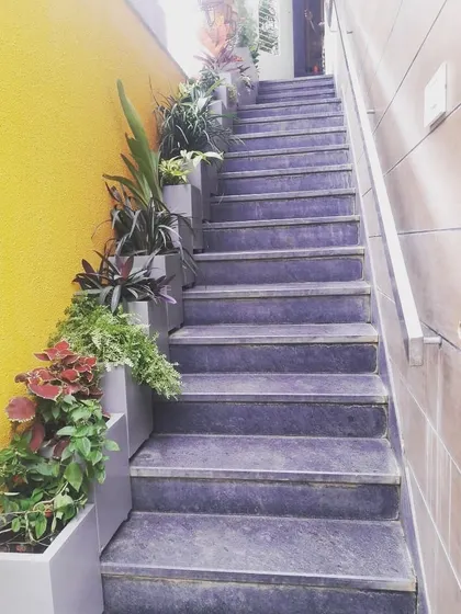 Don't let your staircase be a forgotten space. We used a series of custom-fit planters filled with colorful and textured plants like coleus to turn this stairway into a beautiful, cascading garden.