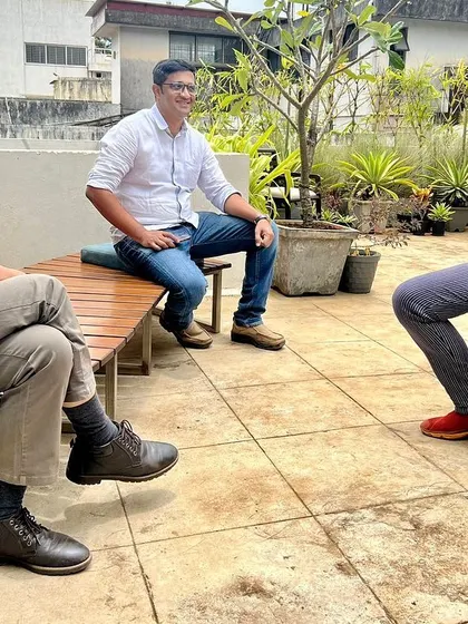 A moment of animated discussion with colleagues. The exchange of ideas, debate, and shared passion are what drive the creative process forward.
