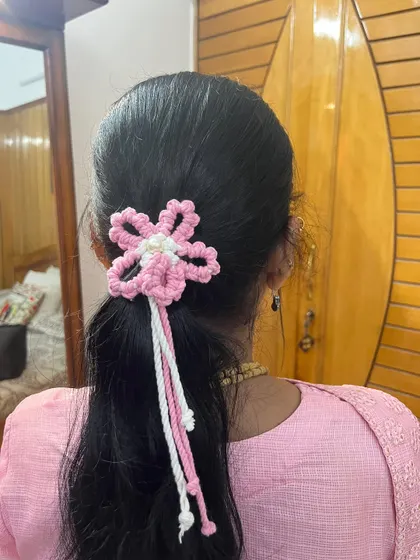 A closer look at the pink and white floral hair tie. The details in the knotting make it a special piece.