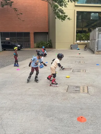 This image captures a typical group lesson, with kids practicing their balance and movement while the coach observes. The safe, enclosed area is perfect for beginners.