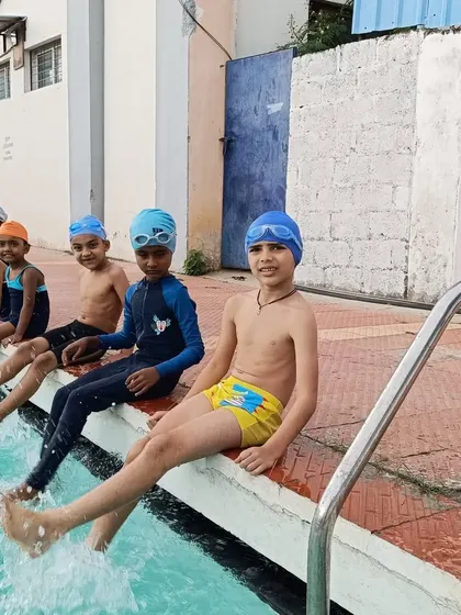 Happy swimmers splashing their feet in the water, a perfect image of the fun we have in our classes.