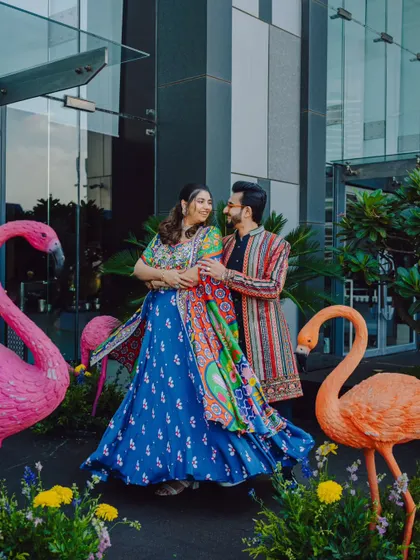 A beautiful portrait of the couple with quirky flamingo decor at their Mehendi carnival.