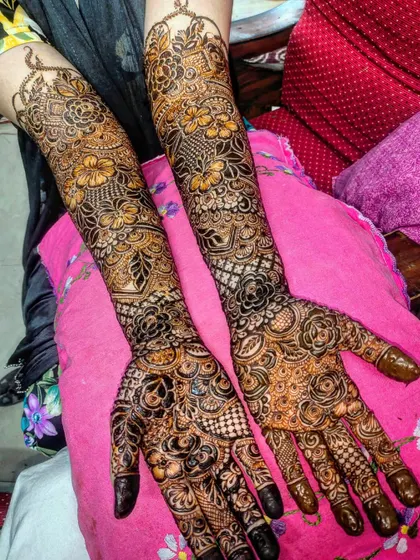 Full coverage bridal henna with a mix of floral, paisley, and geometric elements, resulting in a rich and textured design.