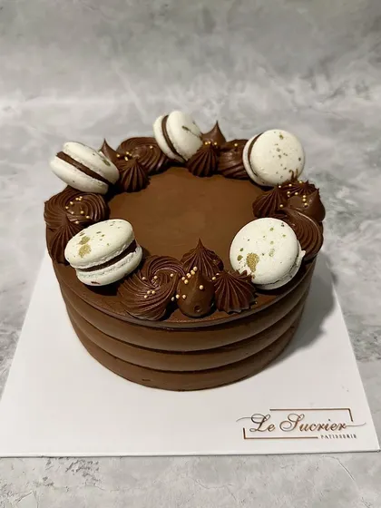 My Decadent Chocolate Cake gets a new look, adorned with delicate white macarons for an elegant contrast.