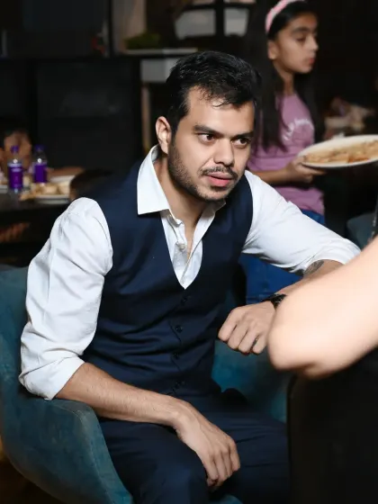 A candid shot of a guest during a conversation at a party. I focus on capturing the natural, unposed moments of the event.