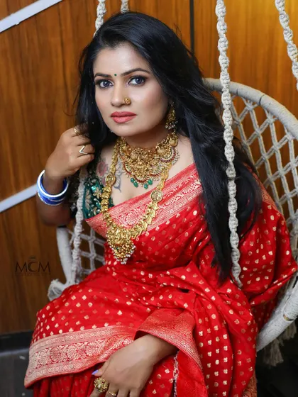 A portrait of elegance. Our client looks stunning in a traditional red saree, showcasing how our outfits are perfect for photoshoots.