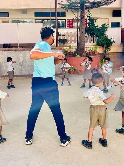 A typical warm-up session in the schoolyard, where I lead the children in simple torso twists. We always start with exercises like this to get the blood flowing and prepare for more active games.