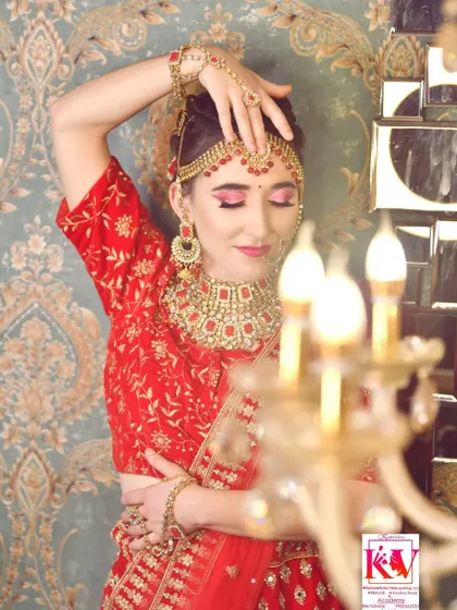 An artistic shot highlighting the classic eye makeup. The soft focus on the candle in the foreground draws attention to the bride's pose and the beautiful details of her makeup and jewellery.