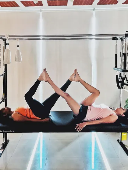 The Pilates community cultivates harmony. This synchronized leg press on the Cadillac shows how we work together to find balance.