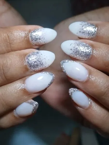 Another view of the milky white and silver glitter ombre nails, showing the beautiful sparkle on the almond-shaped extensions.