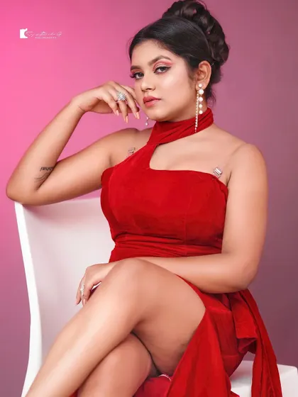 A powerful pose in the red gown. The halter-neck design is very flattering and creates a very glamorous look, perfect for a special event or photoshoot.