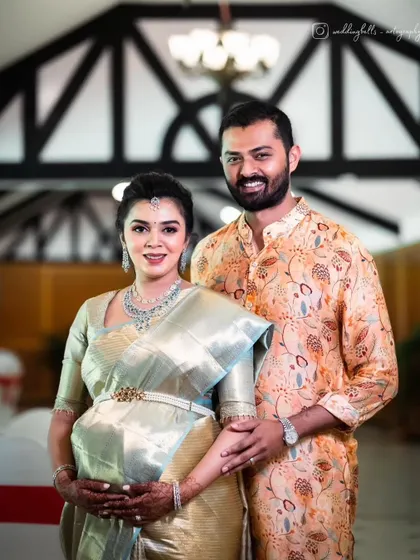 A beautiful portrait of the happy couple at their baby shower. Monica's makeup is classic and radiant, a perfect complement to her stunning silk saree and pregnancy glow.