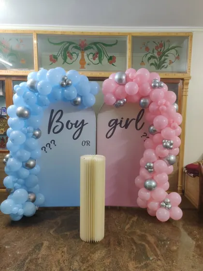 Planning a surprise? Our "Boy or Girl" gender reveal decorations create the perfect moment of anticipation. This setup features two distinct balloon arches in blue and pink, setting a fun and exciting stage for the big reveal.