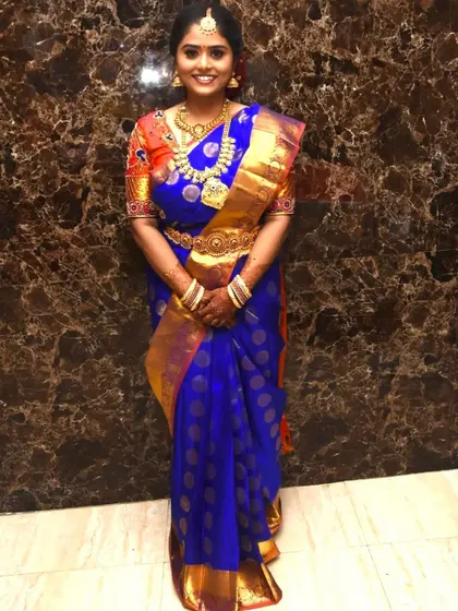 A full-length view of this stunning royal blue Kanjivaram saree. I guide my clients on how to carry themselves with confidence, including posing tips to ensure their photos capture the beauty of their attire.