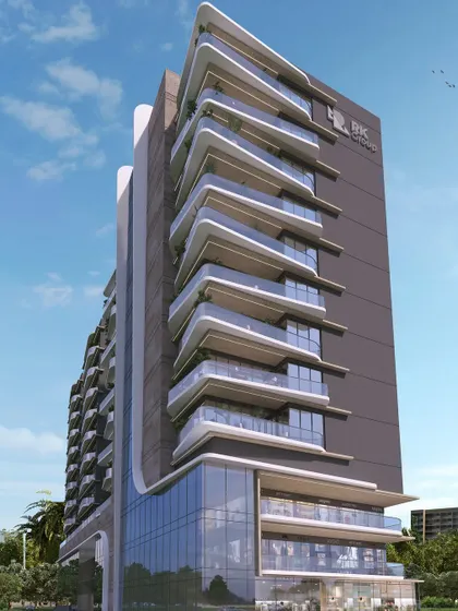 This mixed-use residential structure features a dynamic façade with angled balconies and glass verticals. The design creates a visual contrast between transparency and opacity, with spill-out spaces punctuating the different levels.