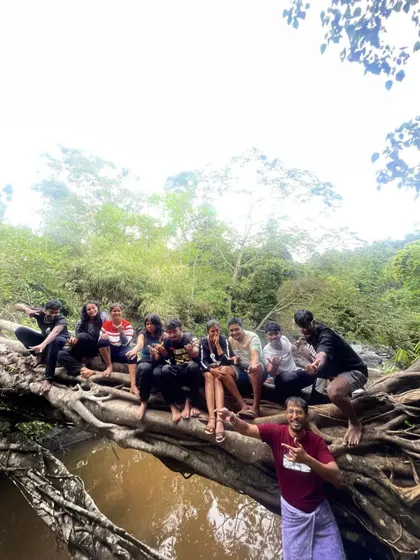 Having fun on a natural bridge made of tree roots.