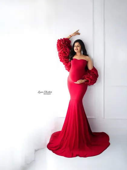A simple white wall is the perfect canvas to let a vibrant gown and a beautiful pose take center stage. This shot is all about elegance and confidence.